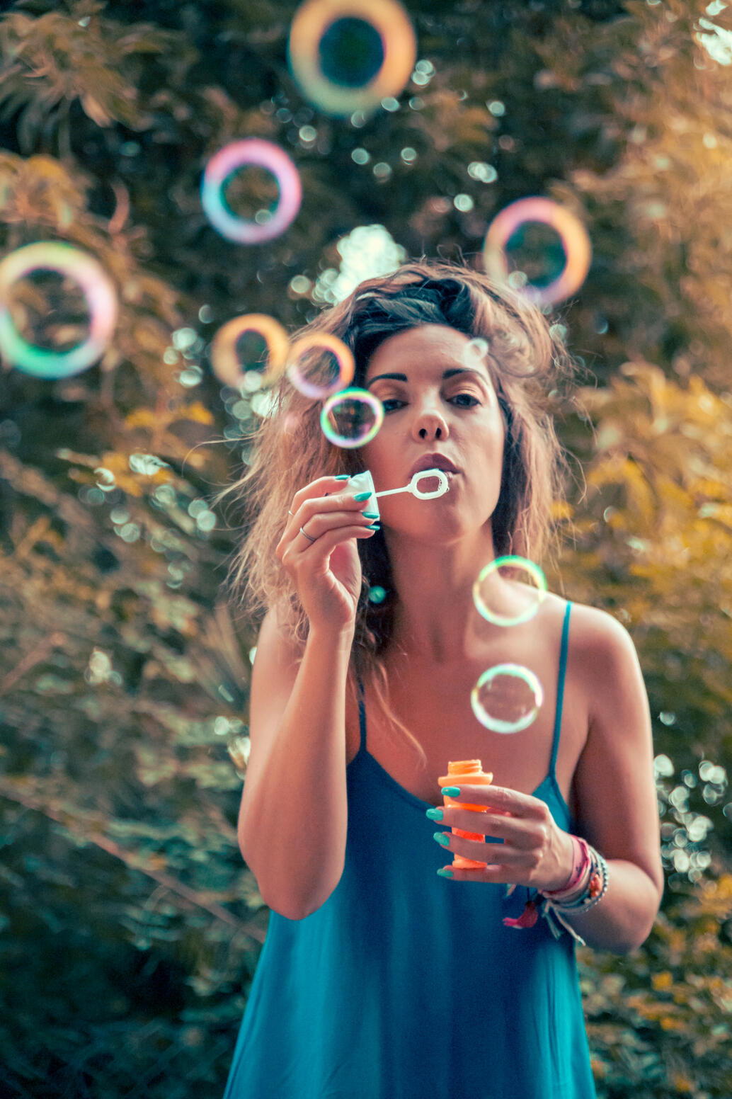Girl blowing bubbles in a park