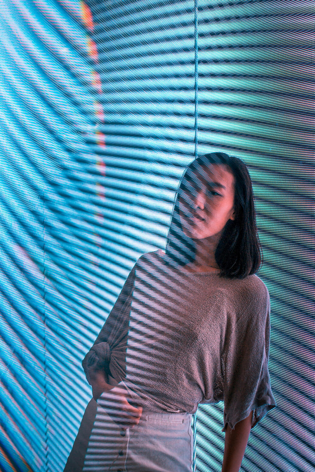 Girl harshly lit by a screen with banding